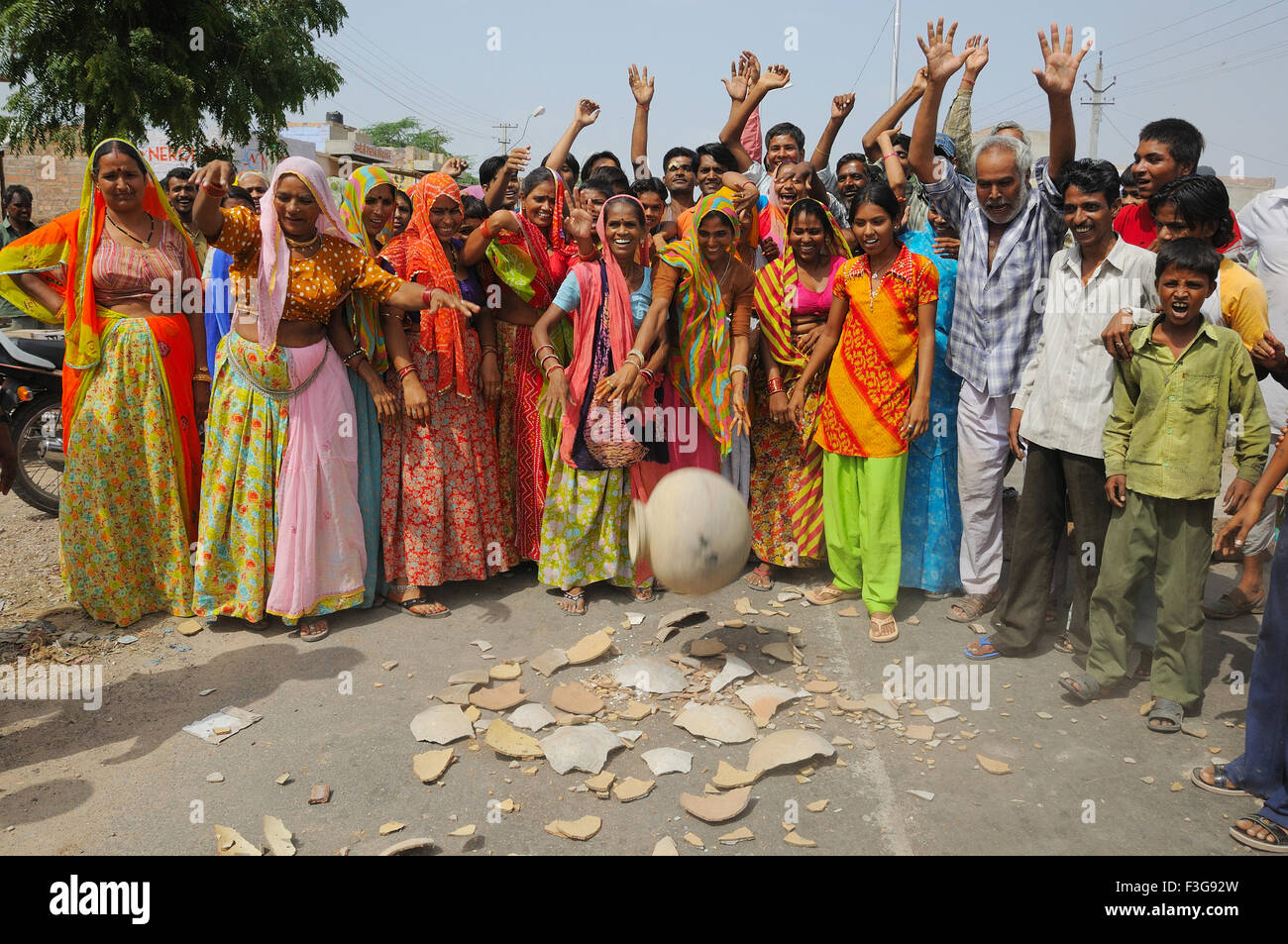 People protesting for water supply and breaking water pot on road