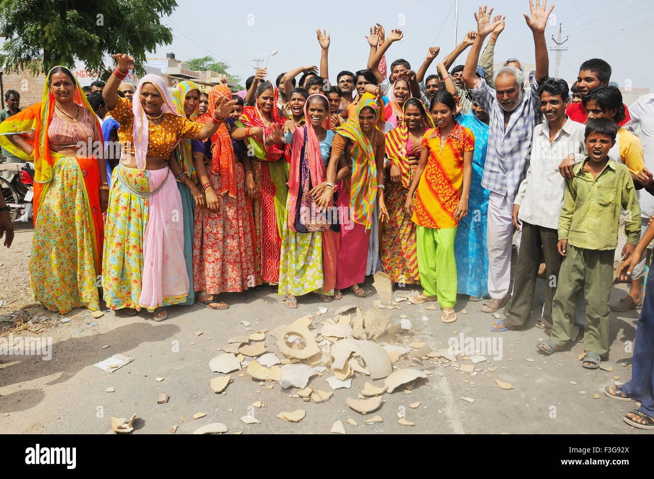 People protesting for water supply and breaking water pot on road