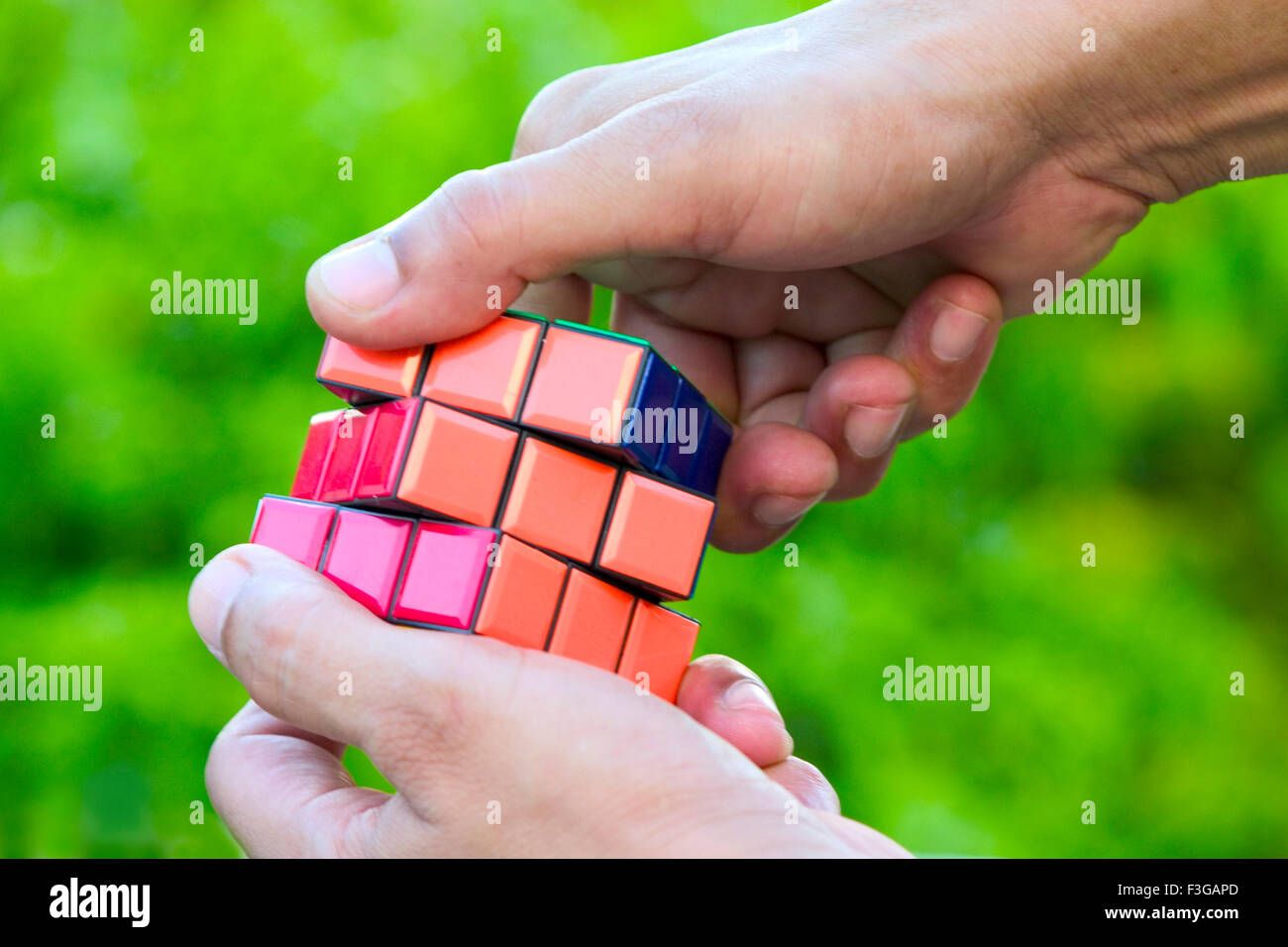 Concept ; Hand playing with Rubik puzzle cube game MR#201 Stock Photo