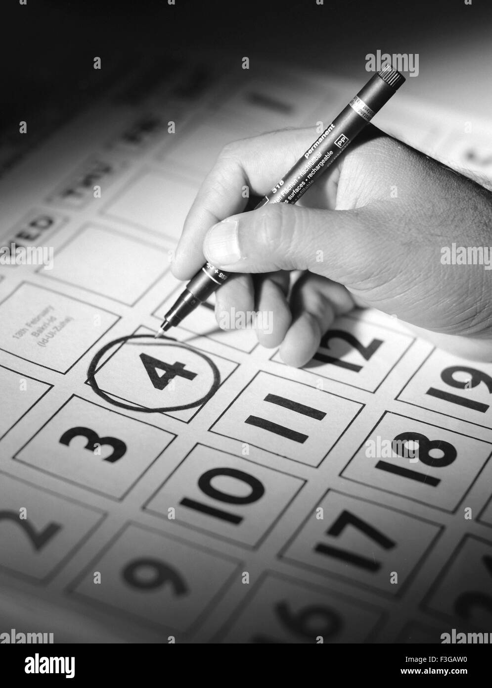Hand marking calendar Stock Photo