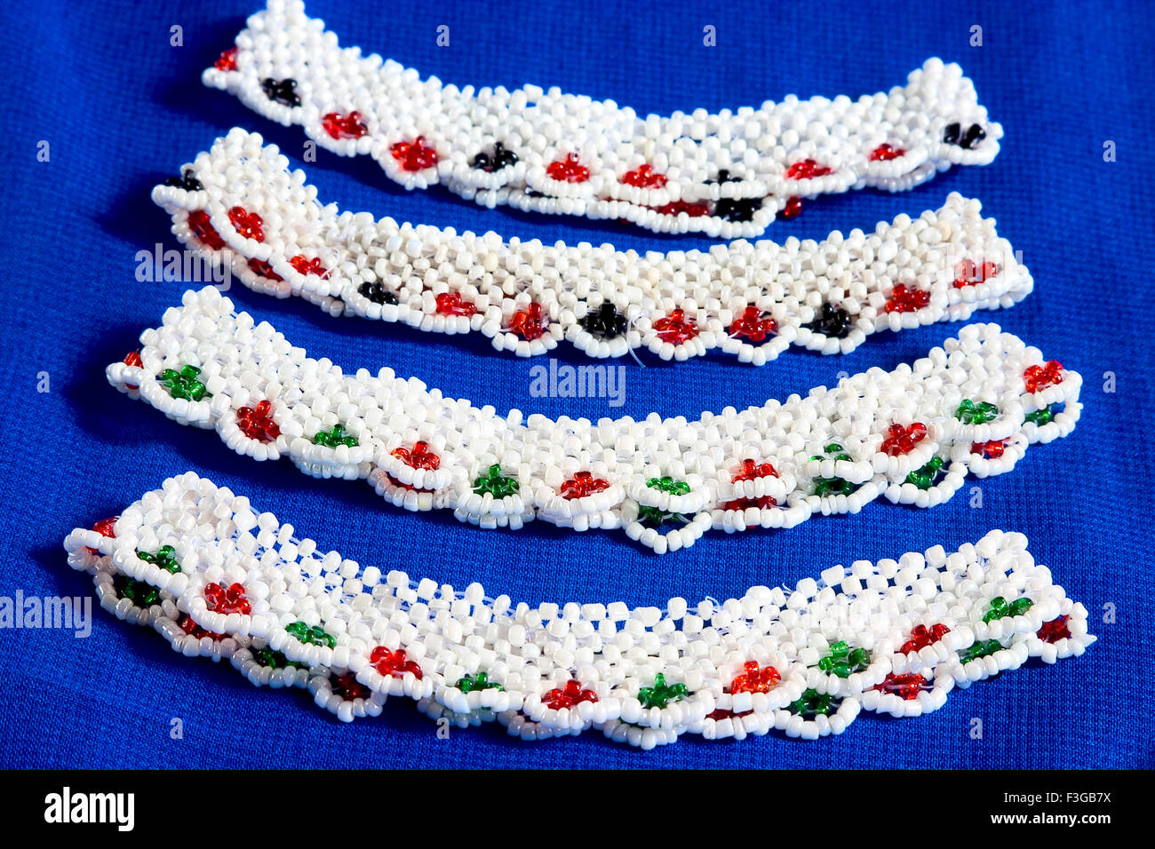 Two Pair of beads anklets on blue cloth Stock Photo