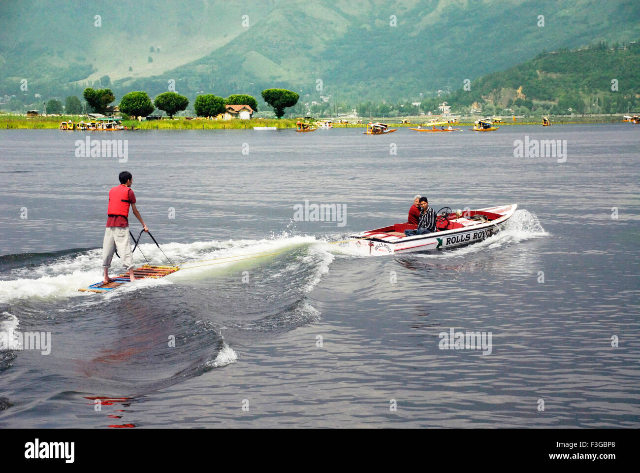 Boy doing water surfing at Dal lake ; Srinagar ; Jammu & Kashmir ; India Stock Photo