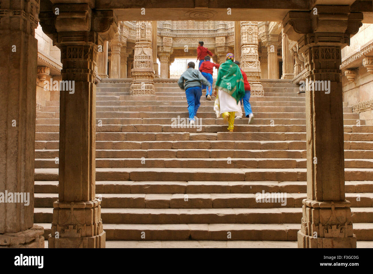 Visitors at Adalaj Vava step well built by Queen Rudabai Heritage site ; Ahmedabad ; Gujarat ; India Stock Photo
