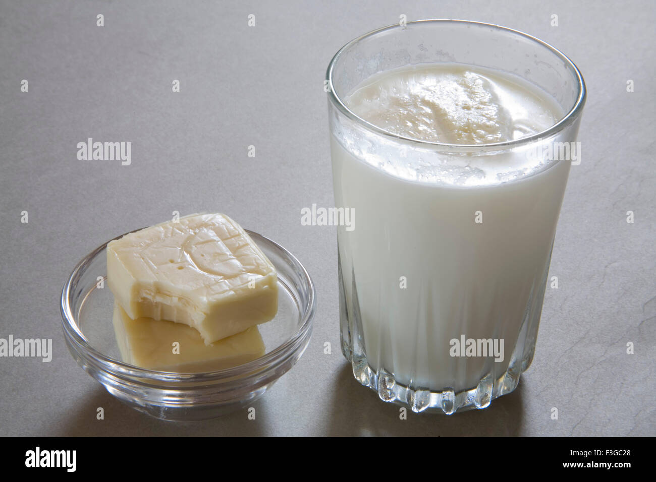 Full glass of milk and cheese made from milk dairy product ; India Stock Photo
