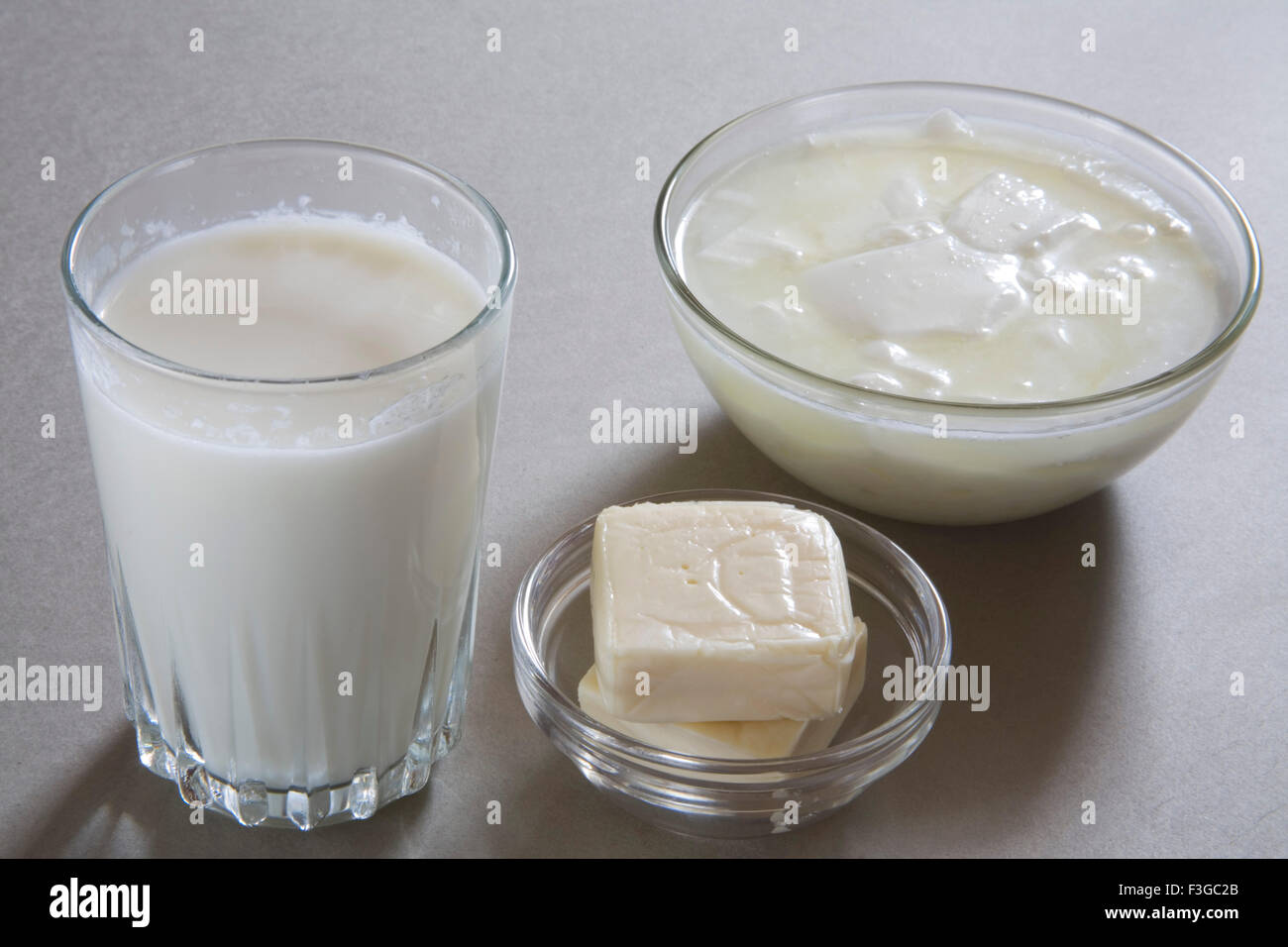 Full glass of milk curd yogurt dahi and cheese made from milk or dairy product ; India Stock Photo