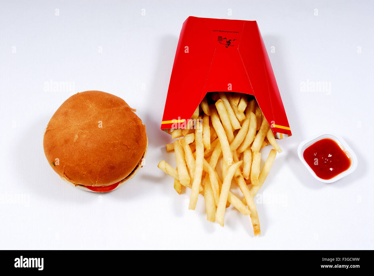 Fries burger and ketchup on white background Stock Photo
