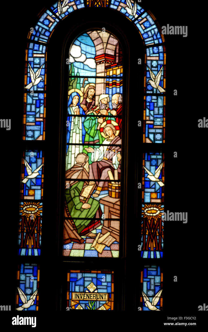 Stained glass of church showing picture of Jesus at Temple talking to Doctors Stock Photo