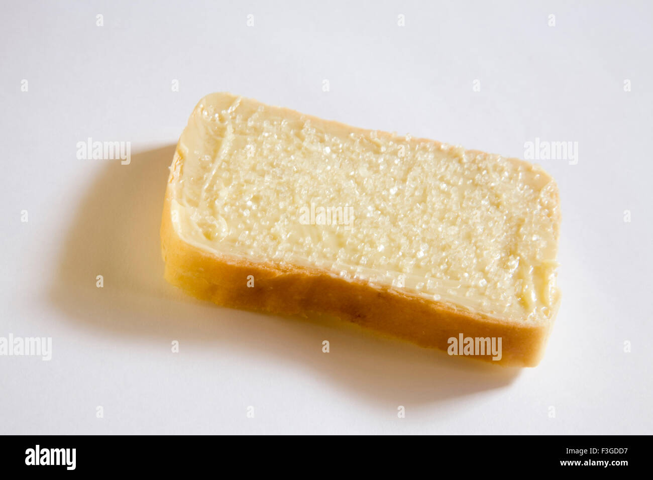 Breakfast food ; butter and sugar applied on single slice of bread Stock Photo