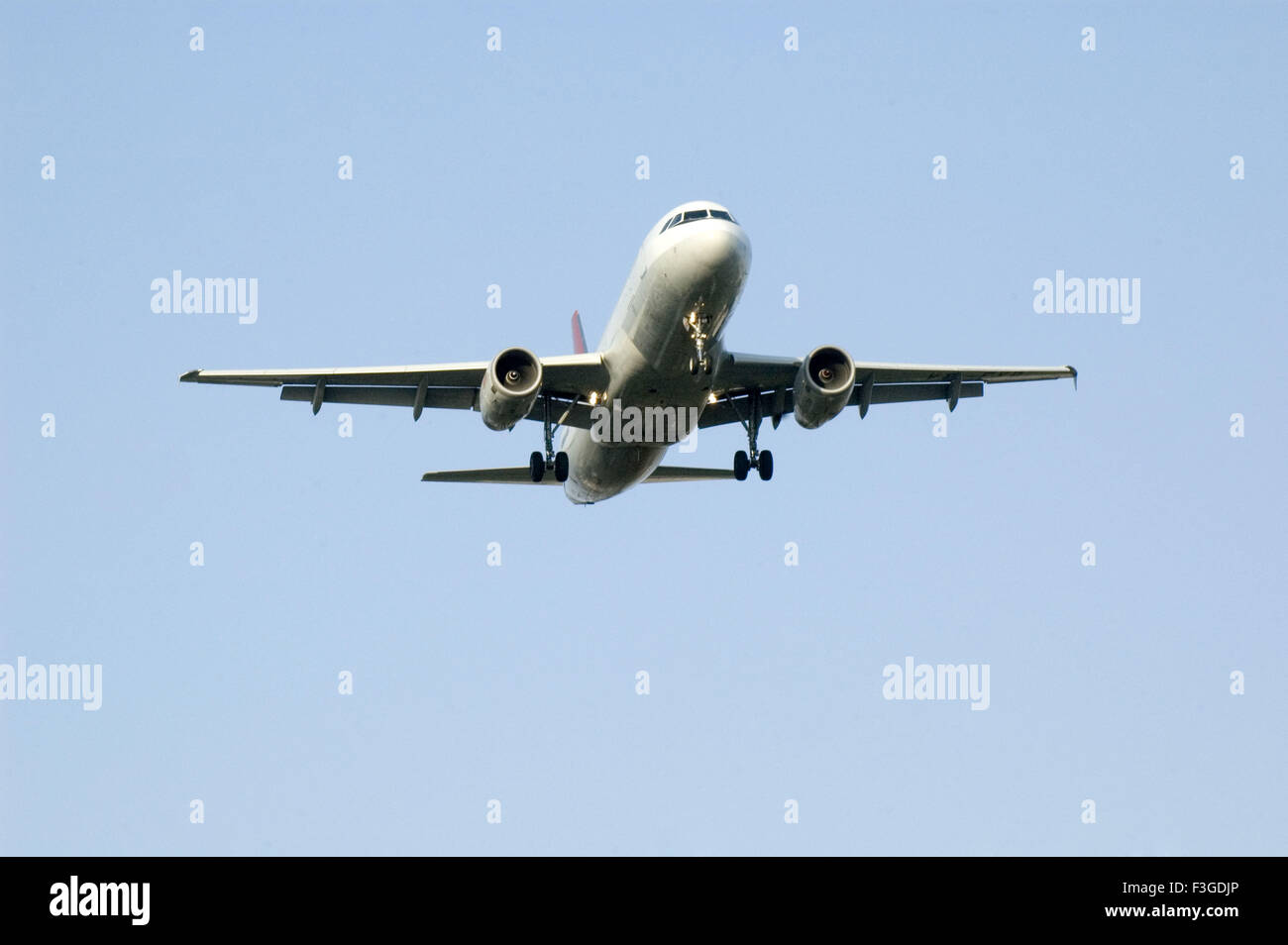 Airplane flying in sky Stock Photo - Alamy