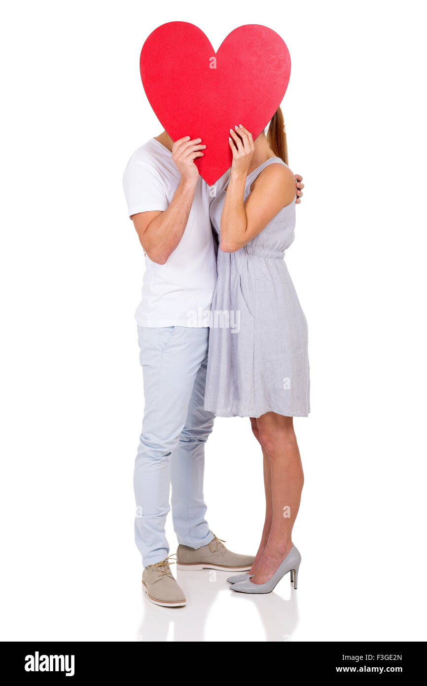 couple kissing behind heart symbol isolated on white background Stock ...