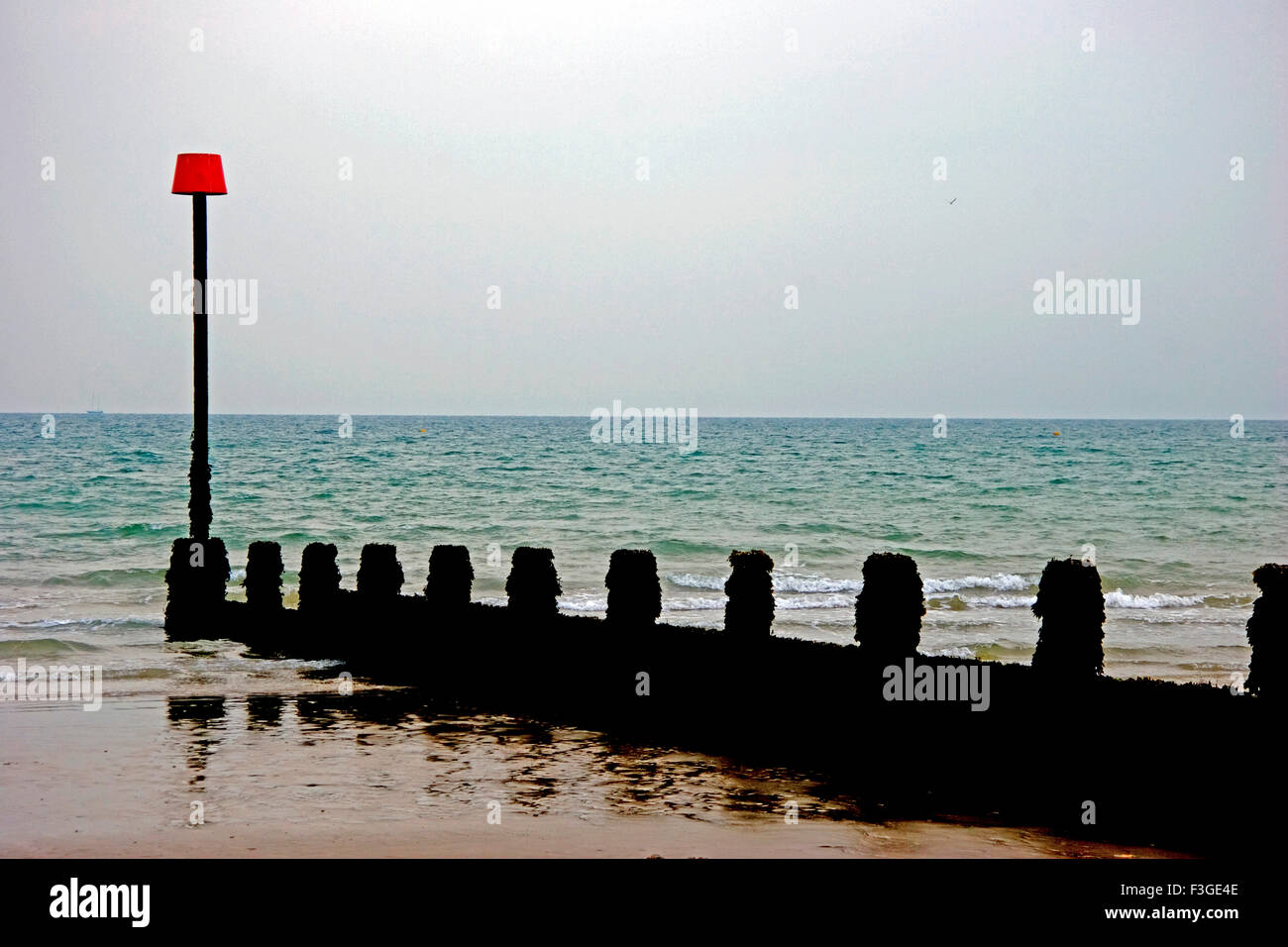 Jetty with Lamppost of Red Lamp Shed at British Sea of South Africa Stock Photo