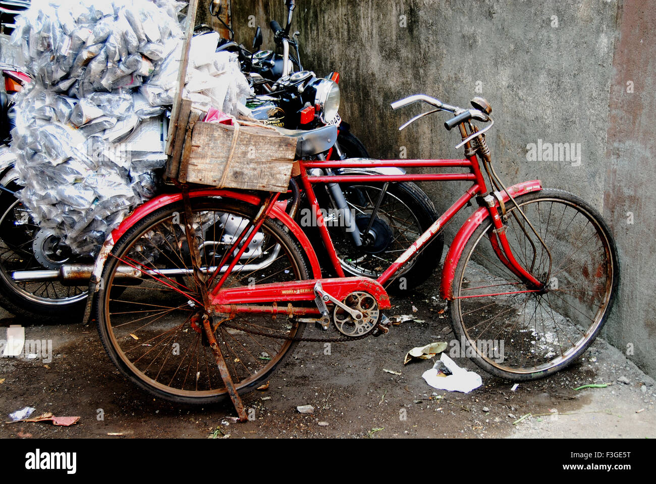 Red Bicycle Being Used For Carrying Rags Stock Photo - Alamy