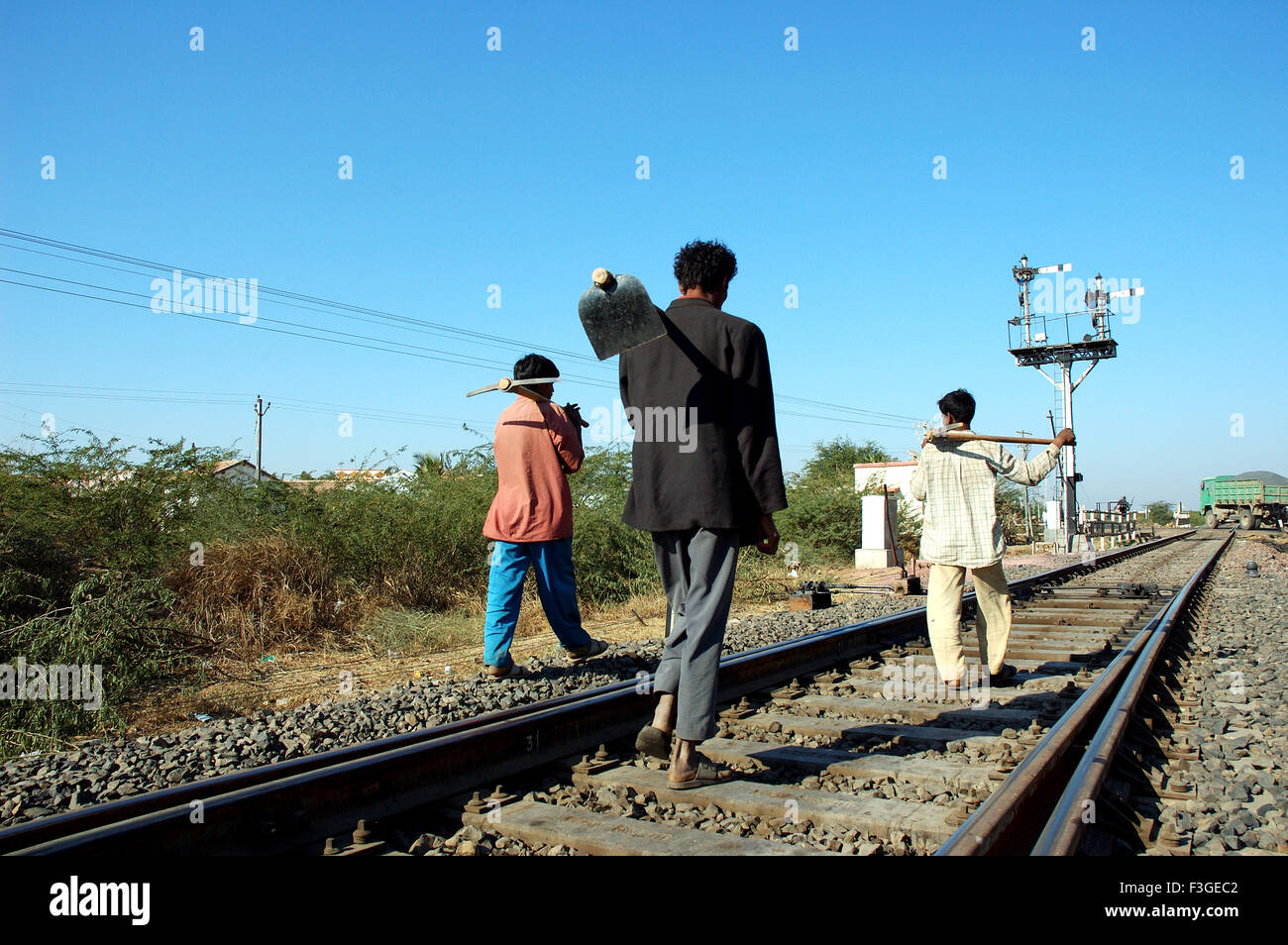 Workers walking in Meterguage railway tracks and signal ; Gujarat