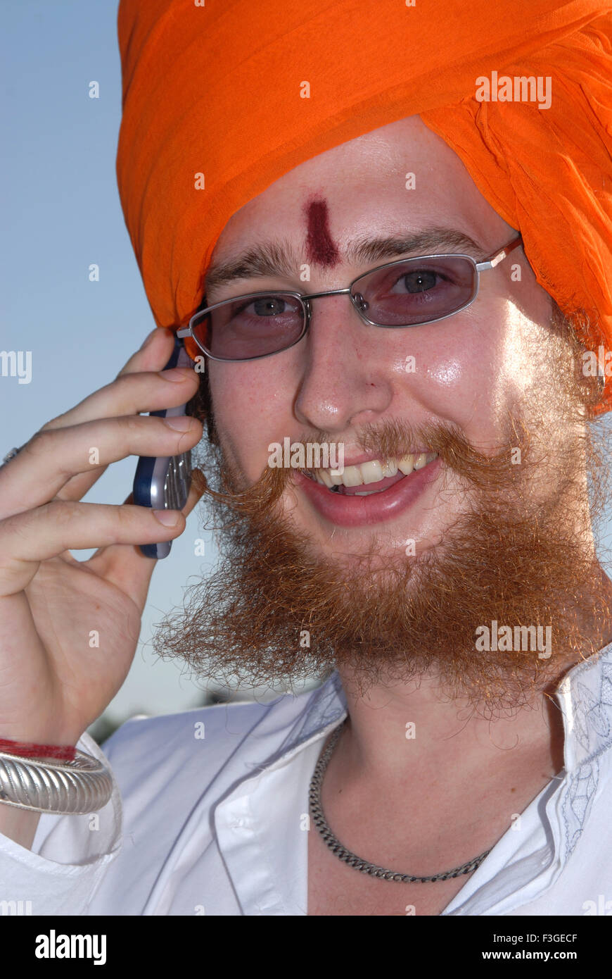 Foreigner man in Rajasthani costume with cell phone ; Jodhpur ; Rajasthan; India MR#682J Stock Photo