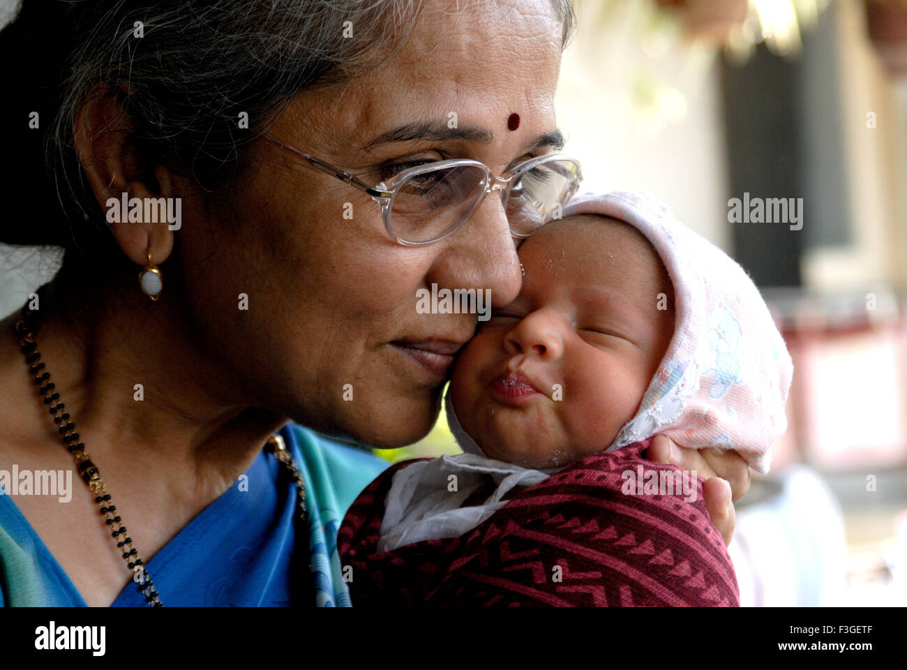 Indian grandmother kissing grandson newborn baby child - MR#364 - rmm 123393 Stock Photo
