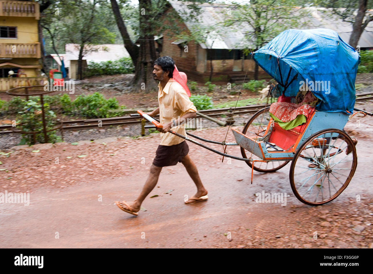 Man driven pulled rickshaw ; Matheran ; Maharashtra ; India Stock Photo