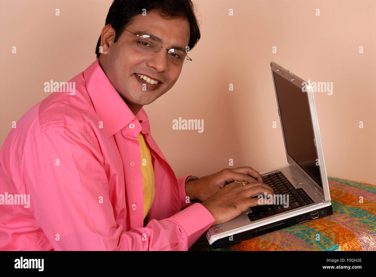 Indian man working on laptop computer India MR#364 Stock Photo - Alamy