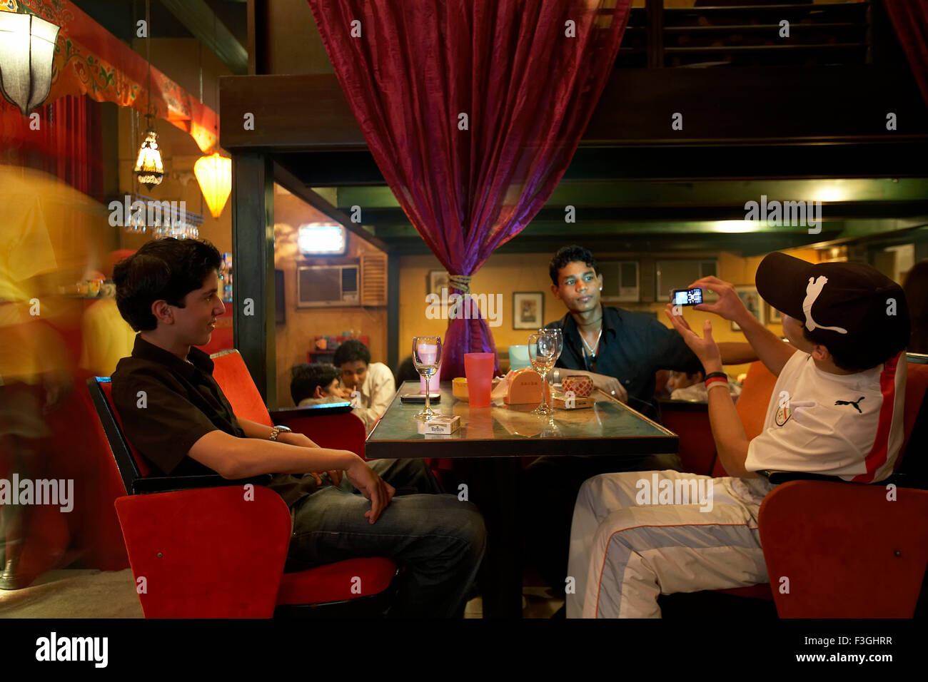 Youngsters having a good time at mocha ; a popular coffee and drinks restaurant in Mumbai Bombay ; Maharashtra ; India Stock Photo