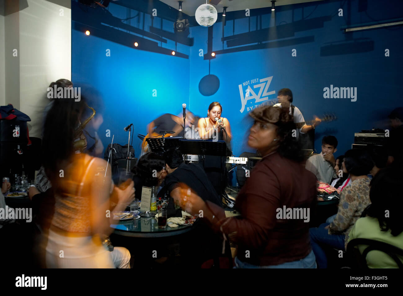 People enjoying live band performance at a popular restaurant Not Just Jazz By The Bay ; Mumbai ; Bombay ; Maharashtra ; India ; Asia Stock Photo