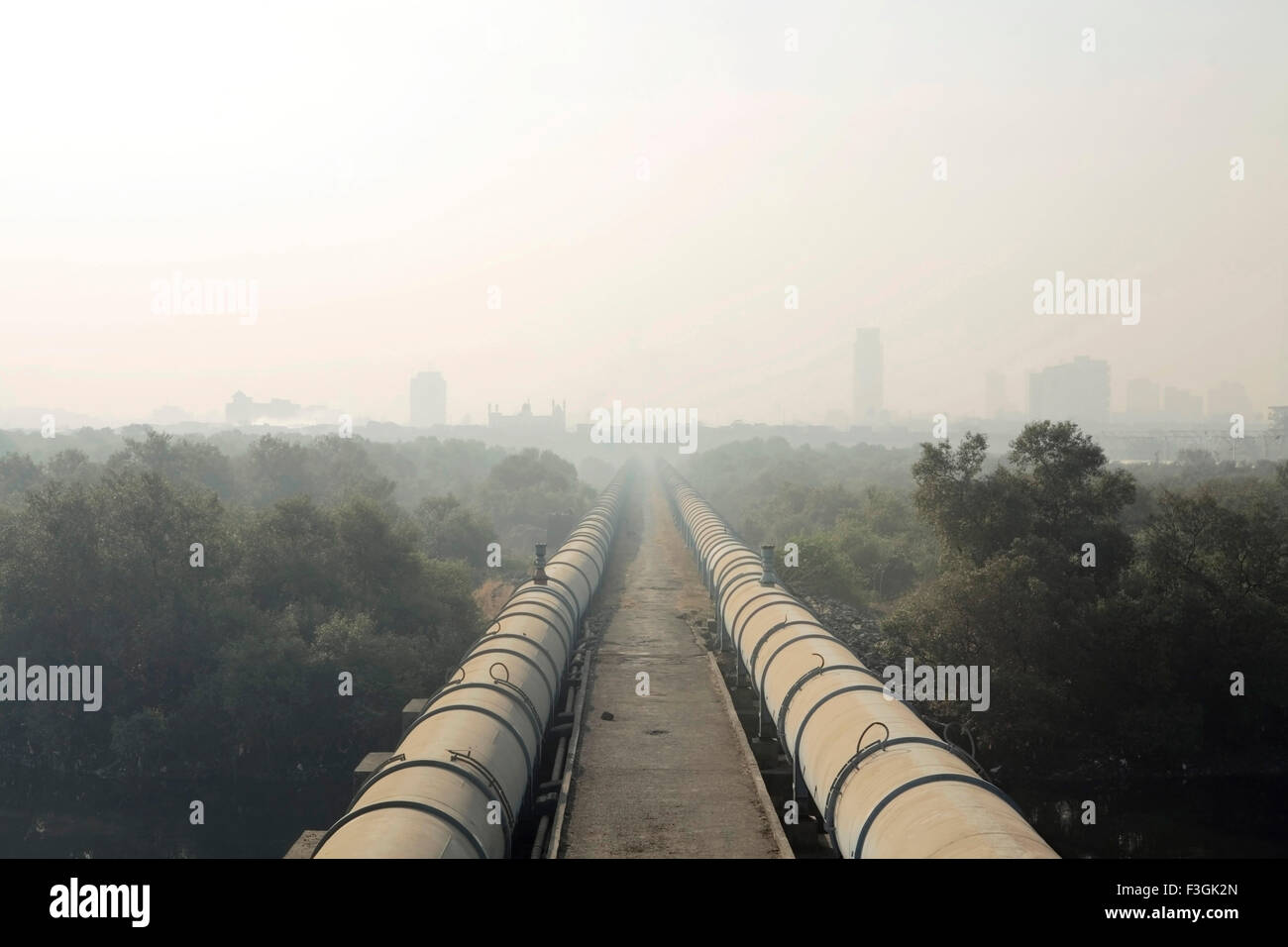 Water pipes to South Mumbai passes through Dharavi draped in smog, Bombay, Mumbai, Maharashtra, India, Asia Stock Photo