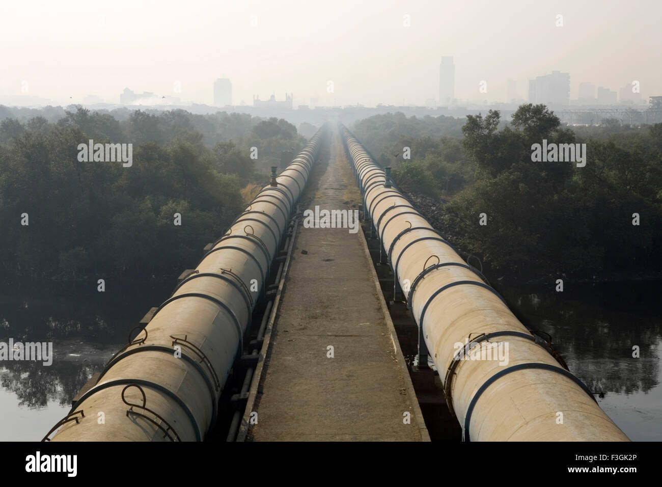 Water pipes to South Mumbai passes through Dharavi draped in smog, Bombay, Mumbai, Maharashtra, India, Asia, Indian, Asian Stock Photo