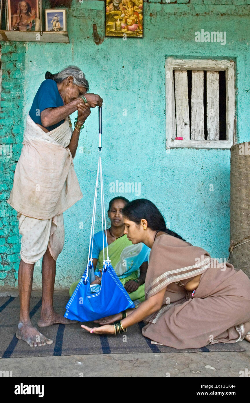 Woman health volunteer explaining village 'dai' traditional midwife