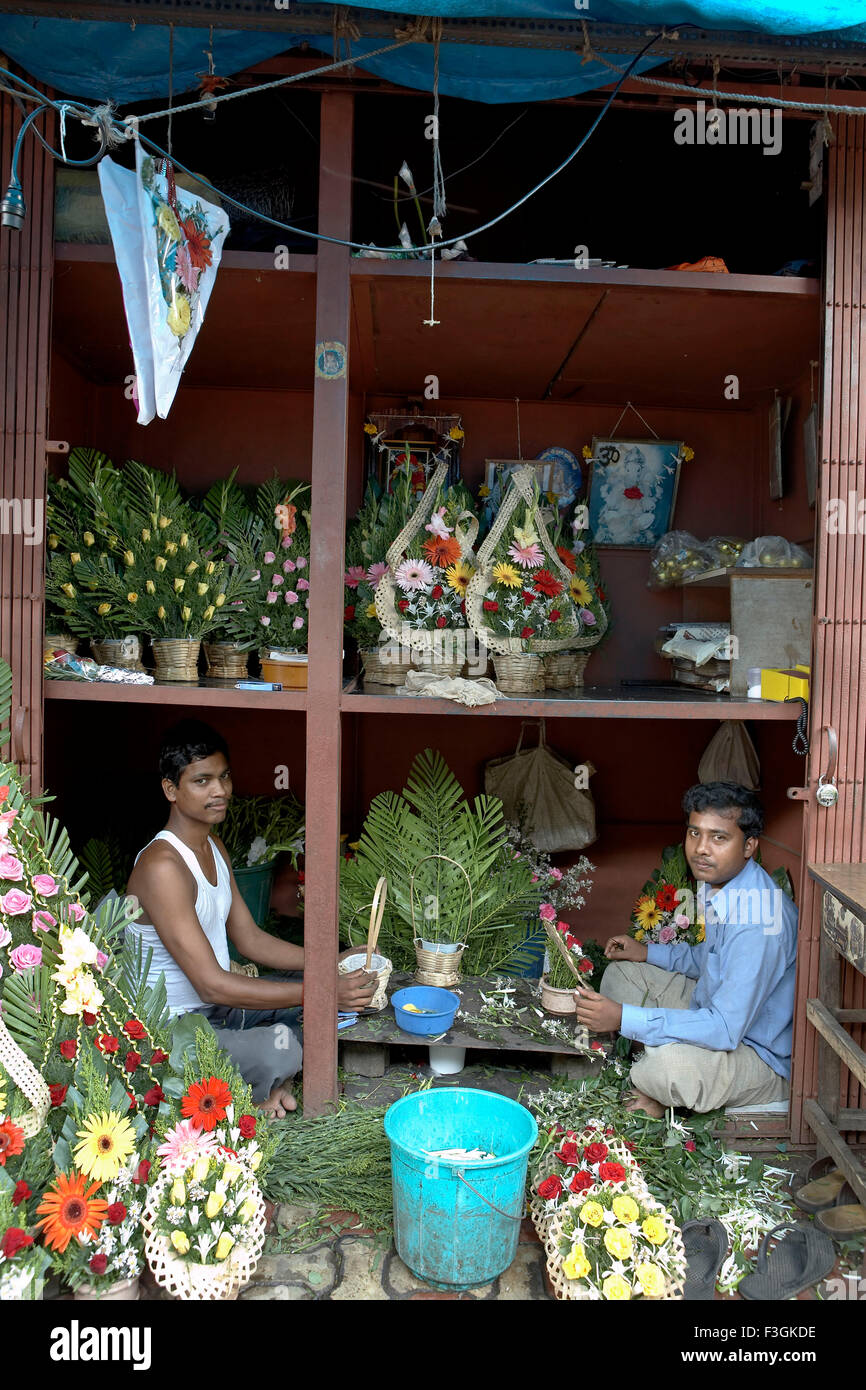 Three layers of a flower vendors shop gives enough room to work ; display and store ; Mumbai Bombay ; Maharashtra ; India Stock Photo
