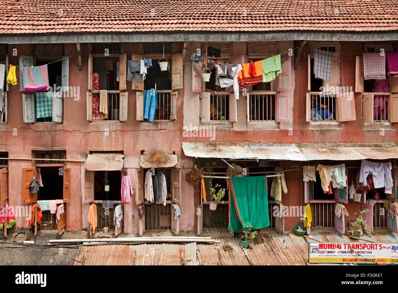 A 'chawl' ; single room housing complex with a common passage ; with shops on the ground floor ; Mumbai Bombay ; Maharashtra Stock Photo
