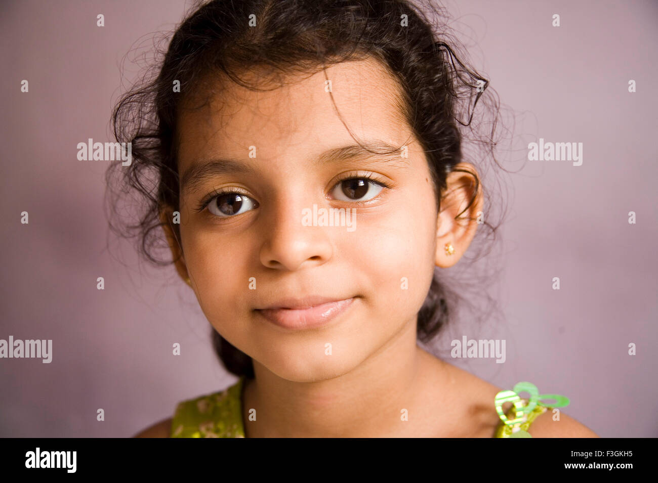 South Asian Indian Seven year old girl Sanchi looking at camera ; Mumbai Bombay ; Maharashtra ; India MR#202 Stock Photo