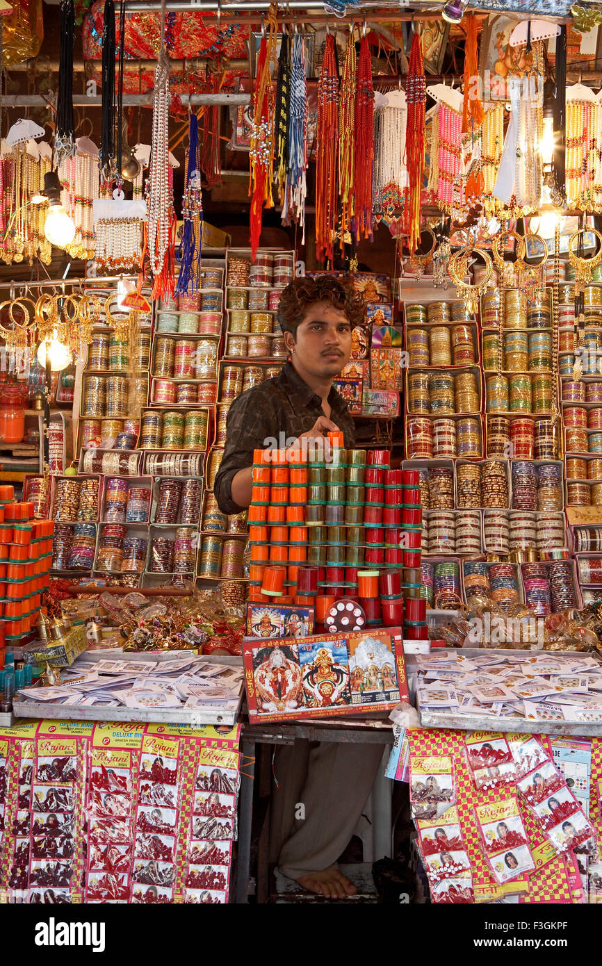 A vendor displays various offering Indian to God outside a temple ; Mumbai Bombay ; Maharashtra ; India Stock Photo