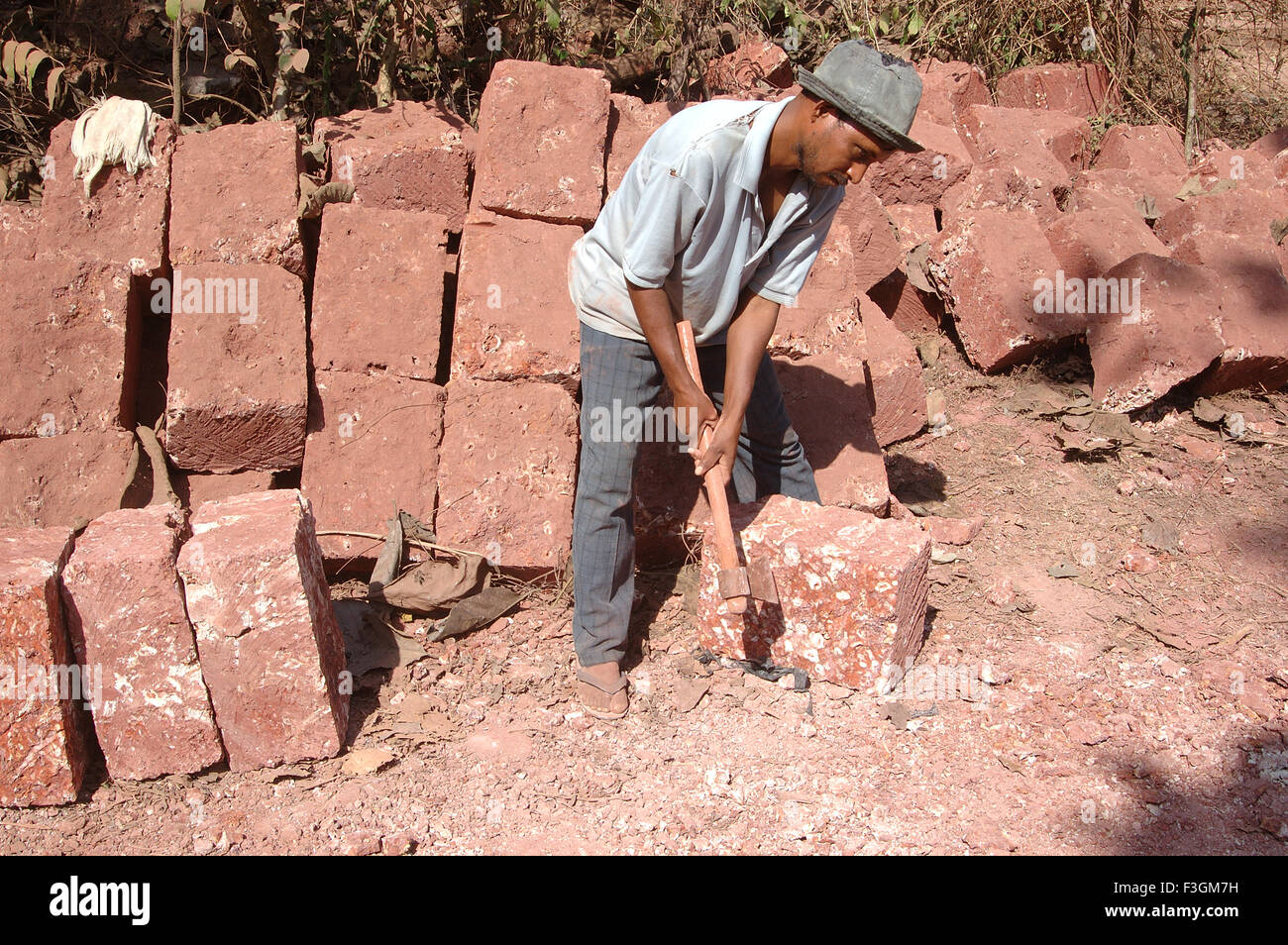 Rural red stone worker at Manche ; Taluka Deogad ; District Sindhudurga ; Maharashtra ; India Stock Photo