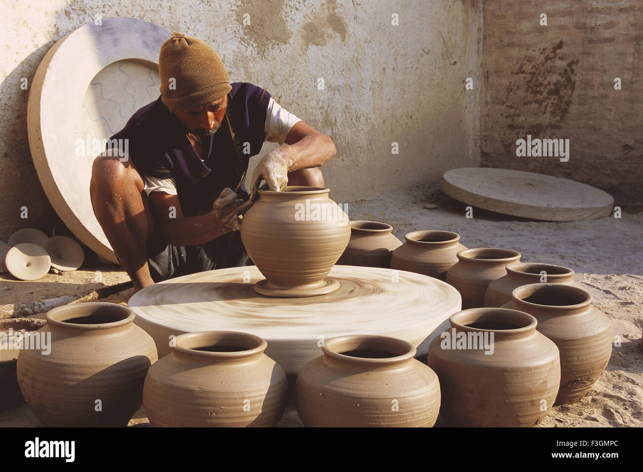 Premium Photo  Potter making a clay object on pottery wheel in