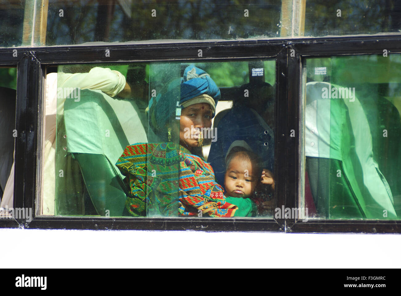 A Garhwali woman with her son in a bus ; Hardwar ; Uttar Pradesh ; India Stock Photo
