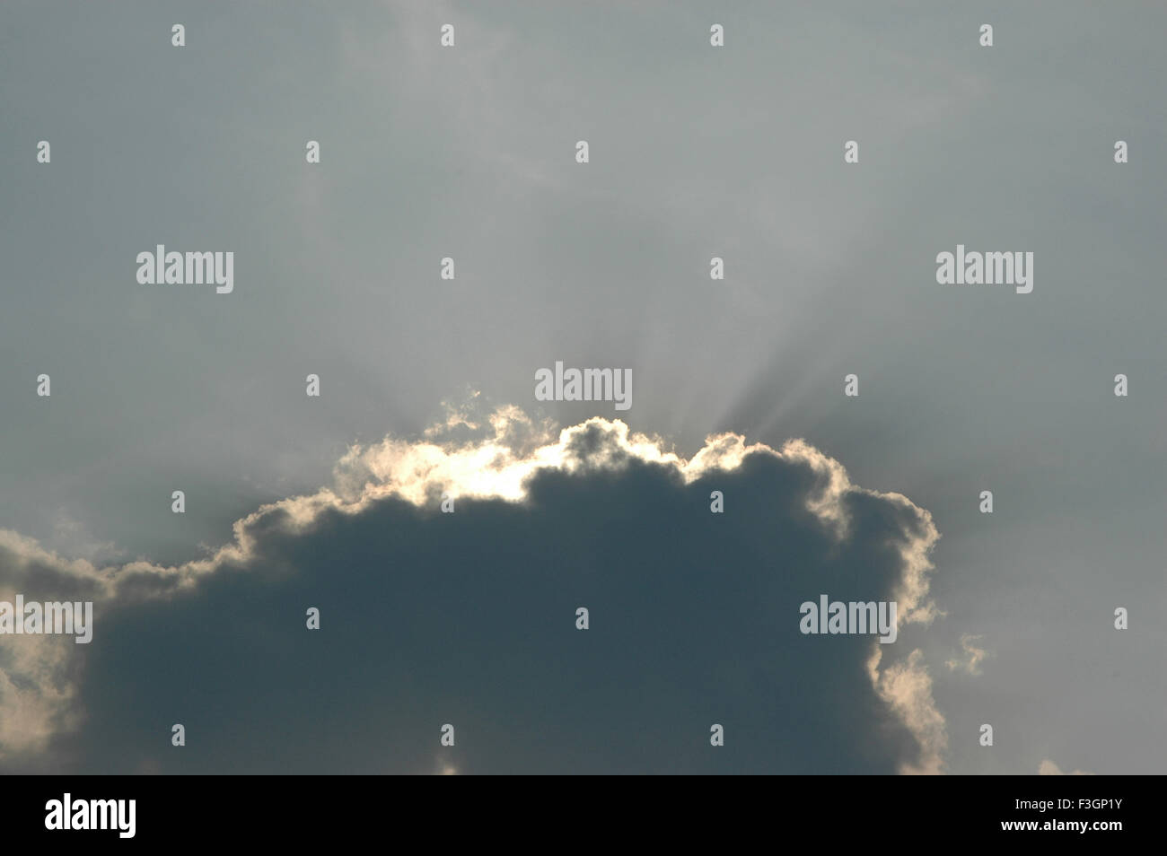 cloud with silver lining, sun hiding behind clouds, sun rays, sunlight, crepuscular rays, Stock Photo
