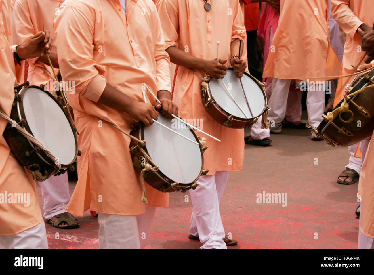 Male playing musical instruments called tasha during immersion of lord