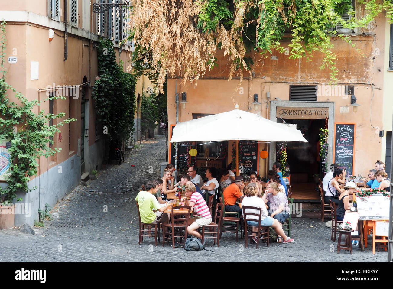 Diners eating al fresco in Trastevere, Rome. Stock Photo