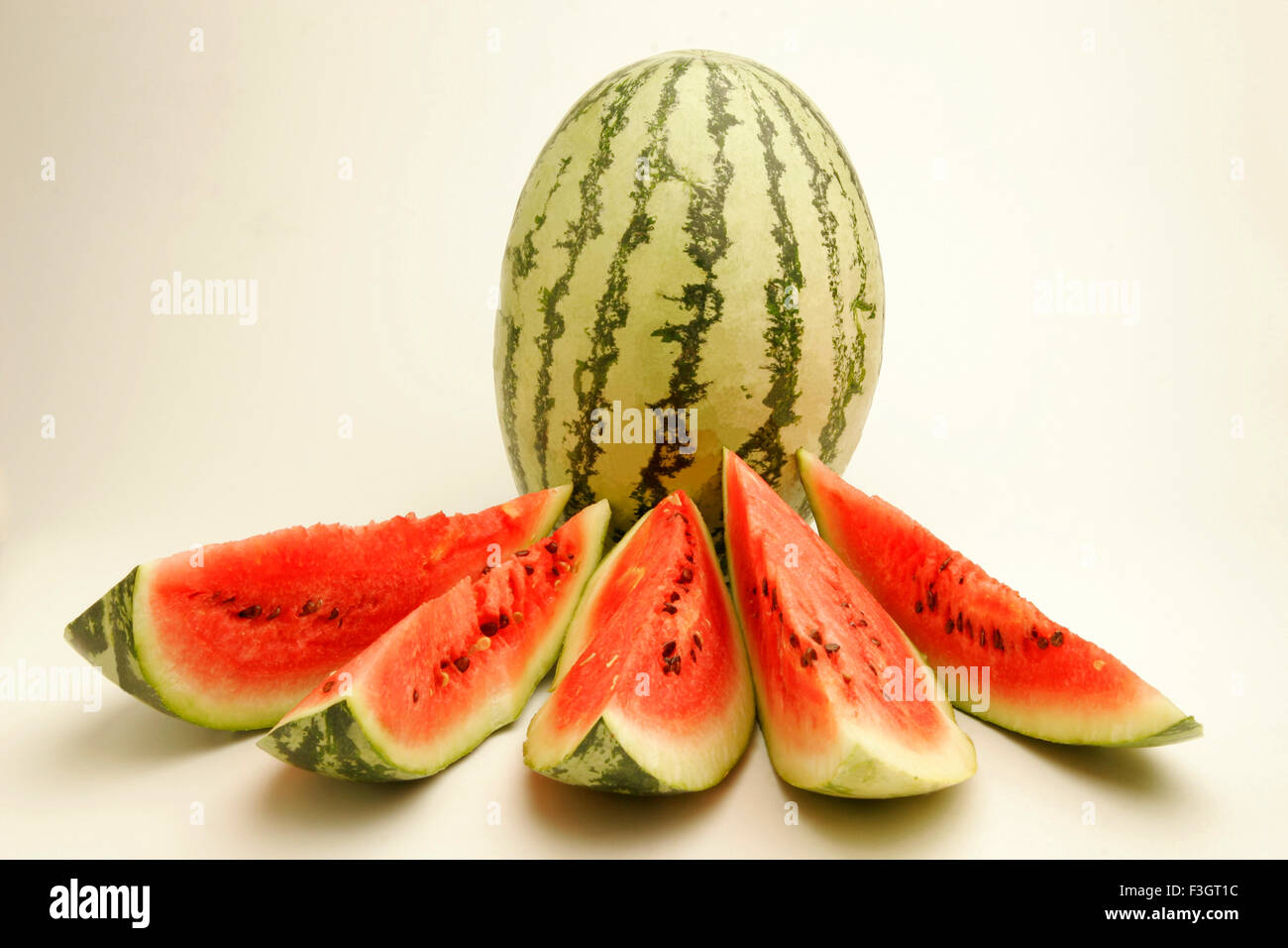 Fruits watermelon light dark green stripes five cut slices showing