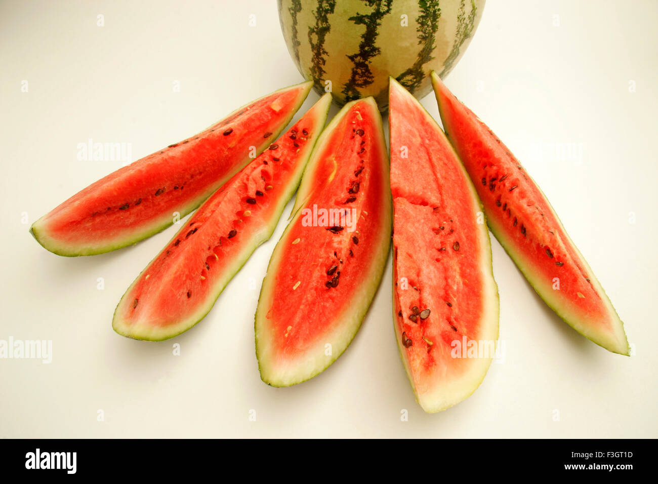 Fruits watermelon light dark green stripes five cut slices showing