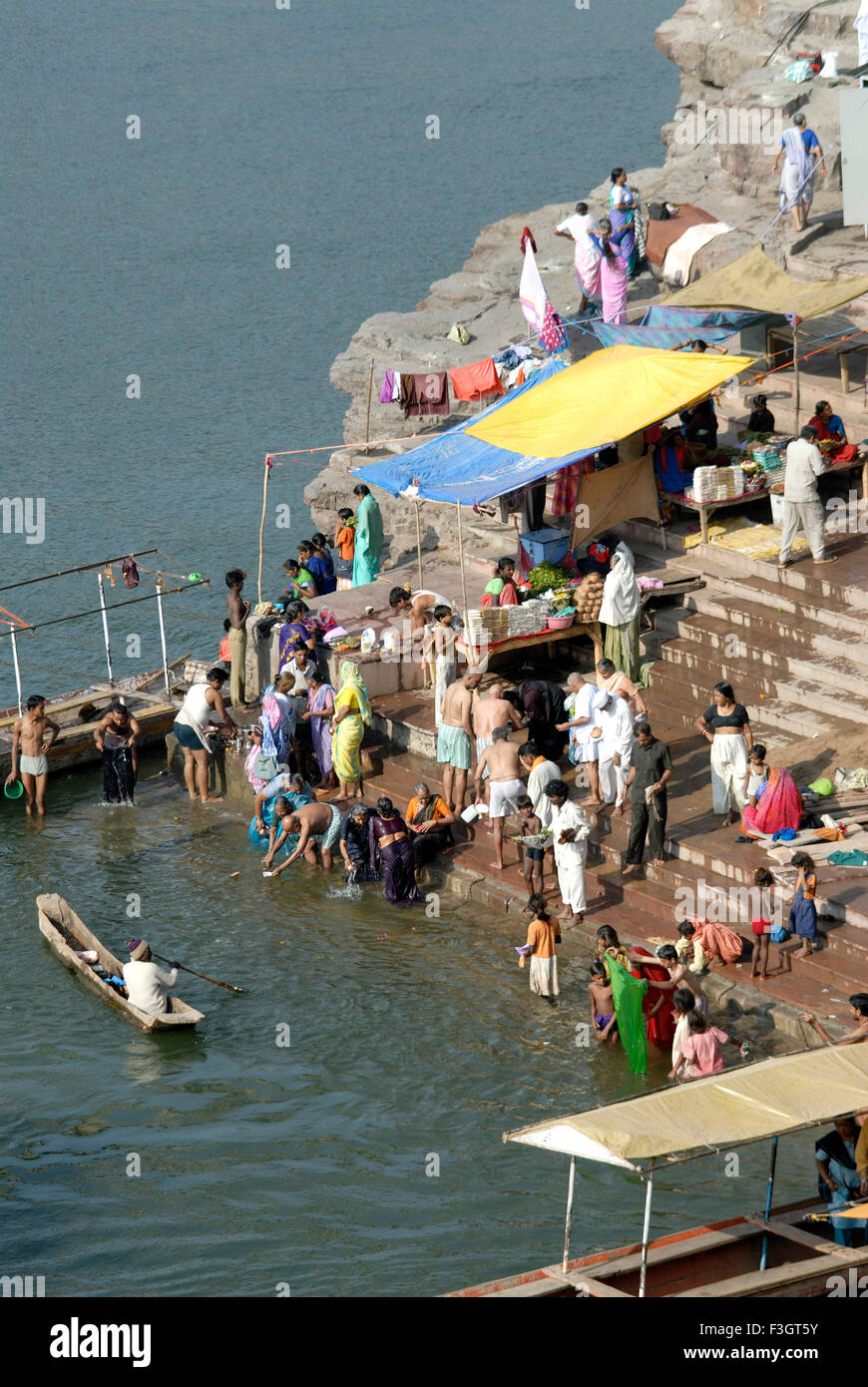 Pilgrims take bath in Narmada at Omkareshwar ; District Khandva ; Madhya Pradesh ; India Stock Photo