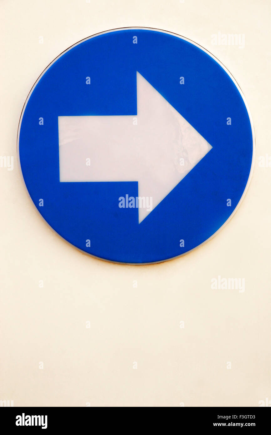 Sign of arrow indicating direction to right in blue and white color ; Pune ; Maharashtra ; India Stock Photo