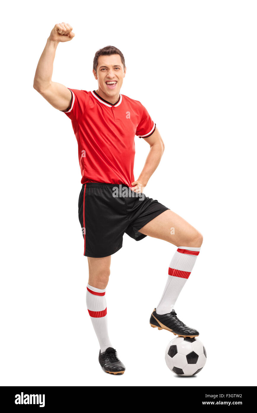 Full length portrait of a joyful football player gesturing happiness and looking at the camera isolated on white background Stock Photo