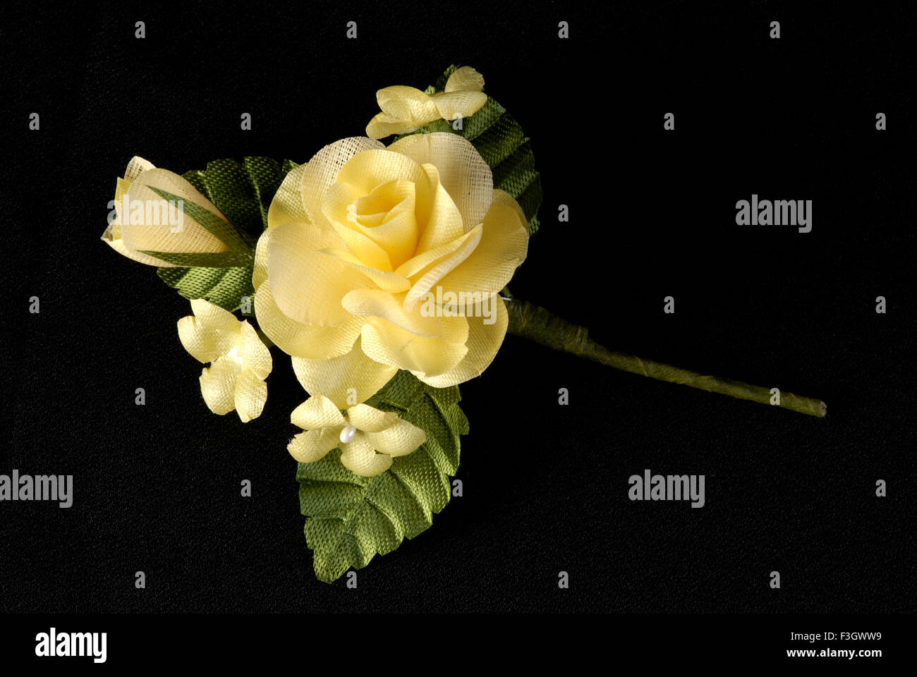 Artificial flowers yellow rose fake flower from sateen cloth, India, Asia Stock Photo
