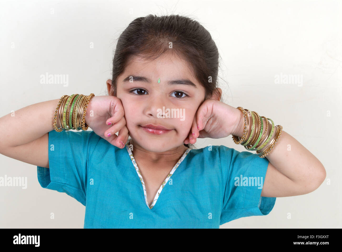 Four years old girl keep hand on cheek MR#556 Stock Photo
