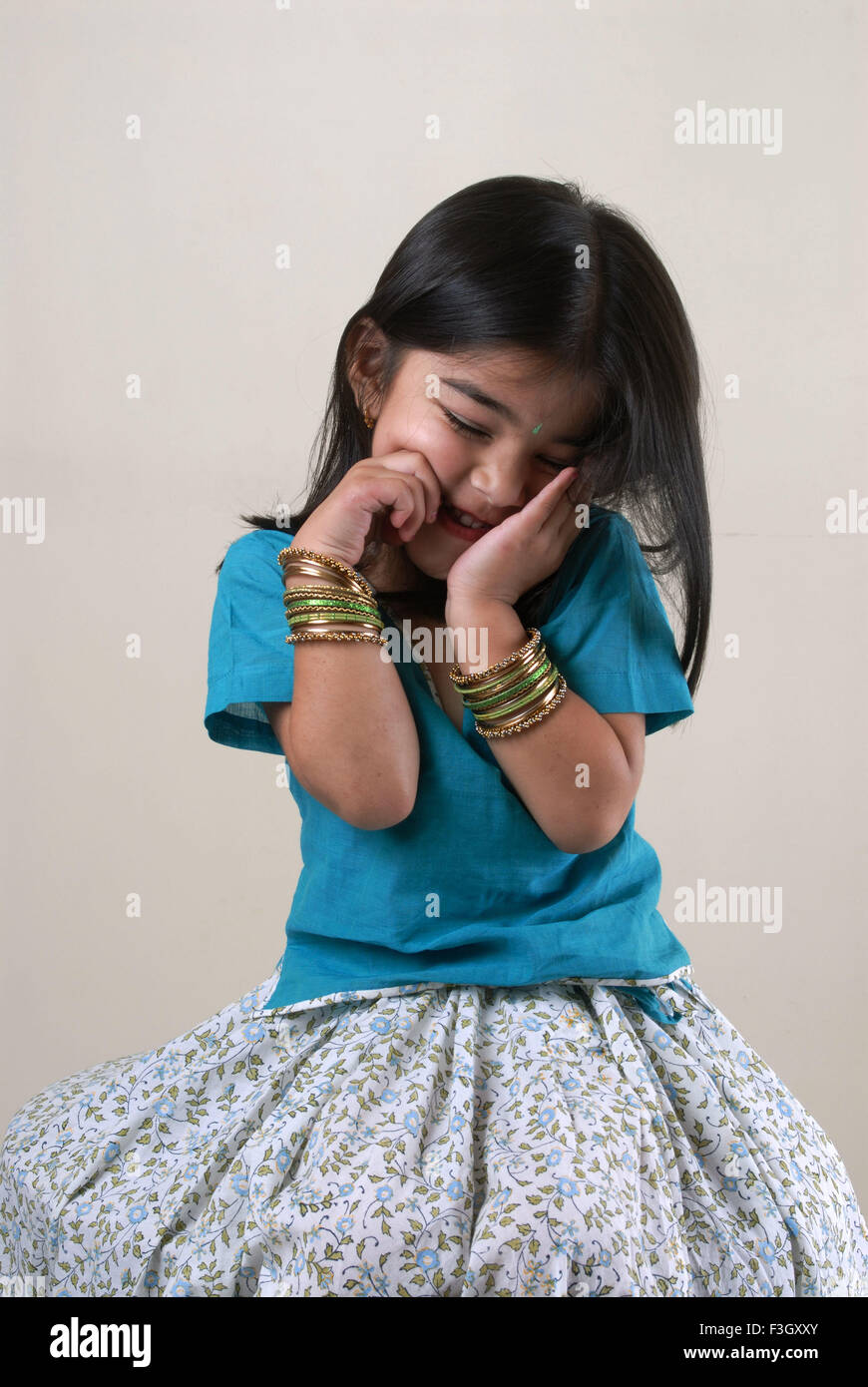 Four years old girl keep hand on cheek showing shyness MR#556 Stock Photo
