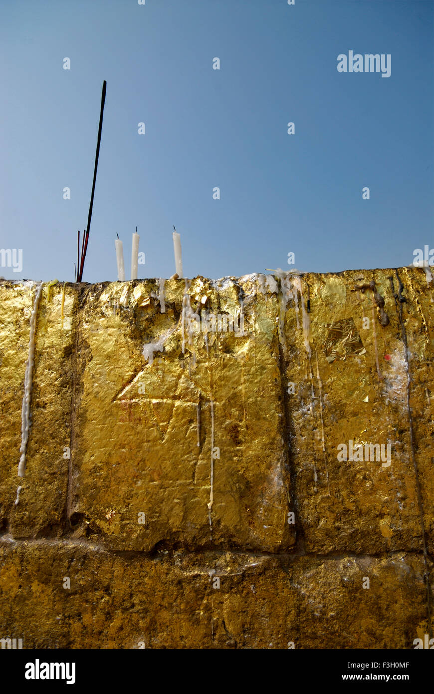 Melted candle wax and gold leaves pasted on walls of shrine of ruined monasteries near Dhamekh stupa Sarnath Varanasi Stock Photo