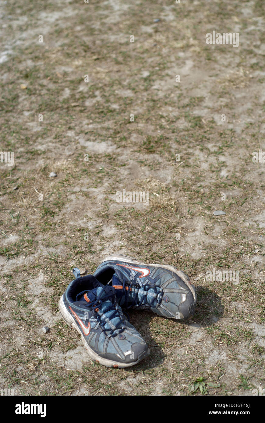 A pair of shoes lying in a playground ; Dehradun ; Uttaranchal ; India