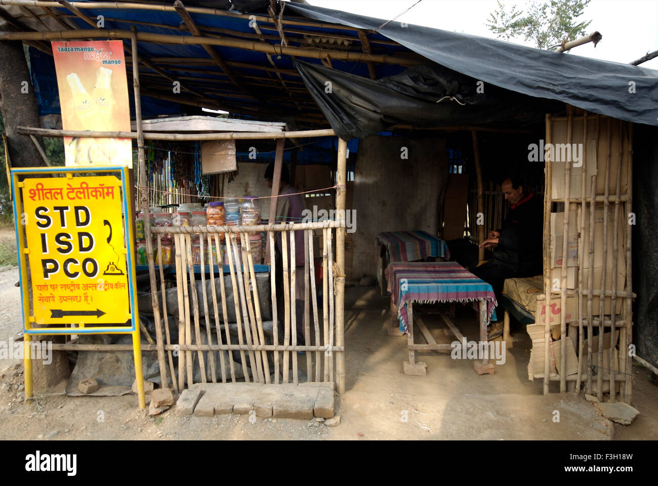 A Roadside tea stall with a telephone booth ; Dehradun ; Uttaranchal ; India Stock Photo