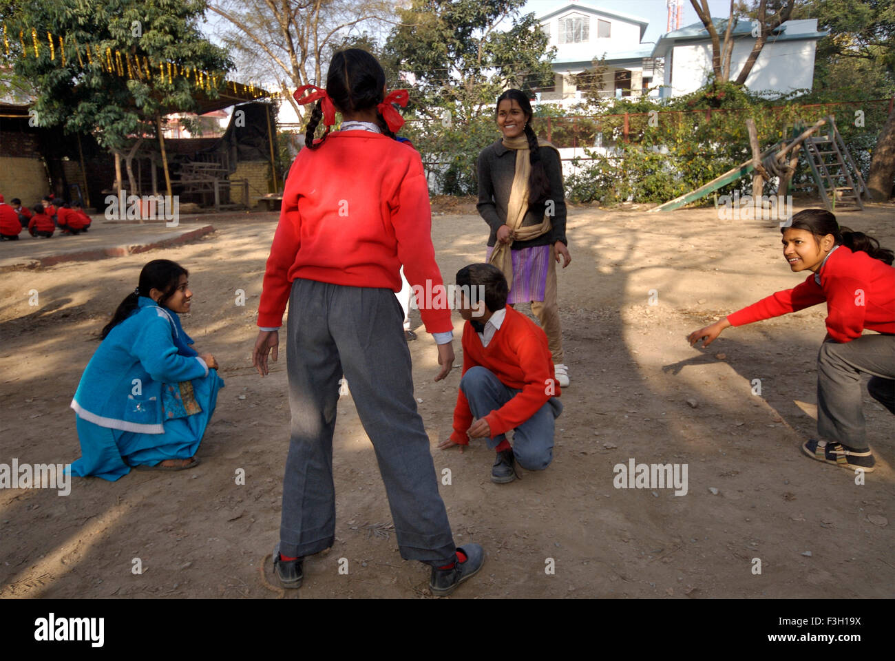Students playing Kho Kho ; Nanhi Duniya school ; Doon School ; Dehradun ; Dera Doon, Uttaranchal, Uttarakhand, India, Asia, Asian, Indian ; MR#711 Stock Photo
