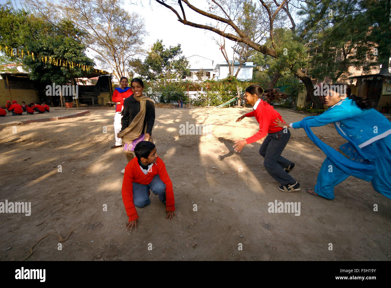 Students playing Kho Kho ; Nanhi Duniya school ; Doon School ; Dehradun ; Dera Doon, Uttaranchal, Uttarakhand, India, Asia, Asian, Indian ; MR#711 Stock Photo