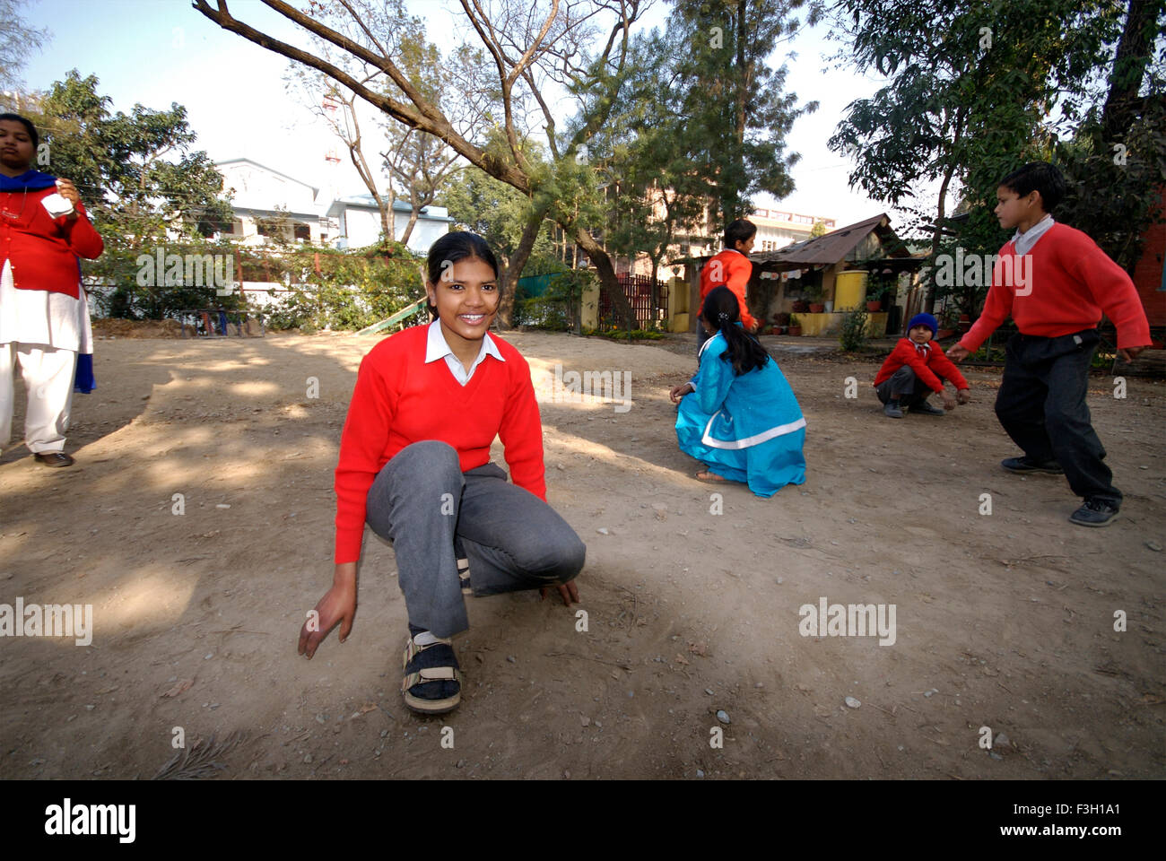 Students playing Kho Kho ; Nanhi Duniya school ; Doon School ; Dehradun ; Dera Doon, Uttaranchal, Uttarakhand, India, Asia, Asian, Indian ; MR#711 Stock Photo